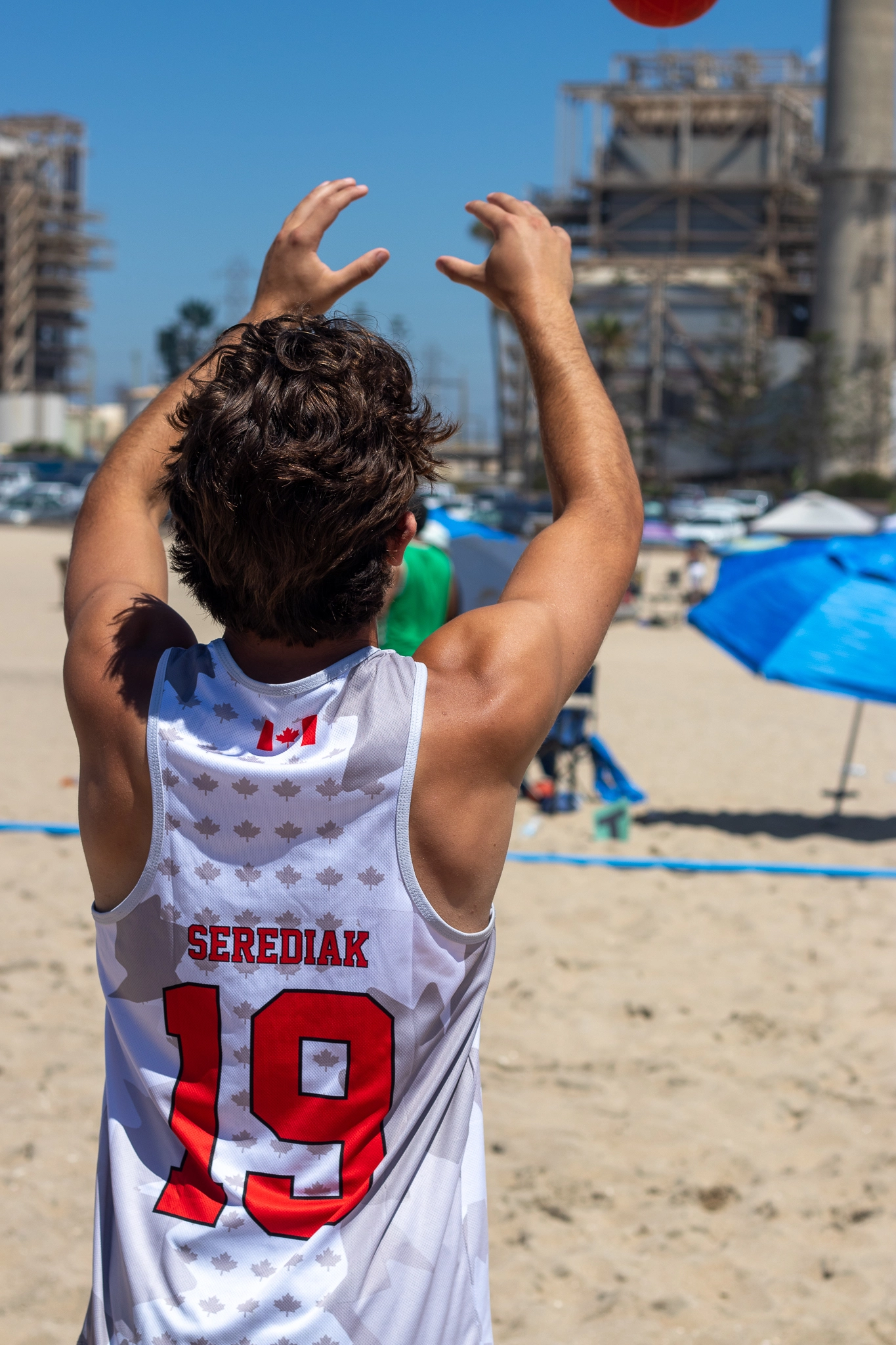 Canadian National Beach Handball Team — player #19 Serediak serving, custom white maple leaf sublimation singlet