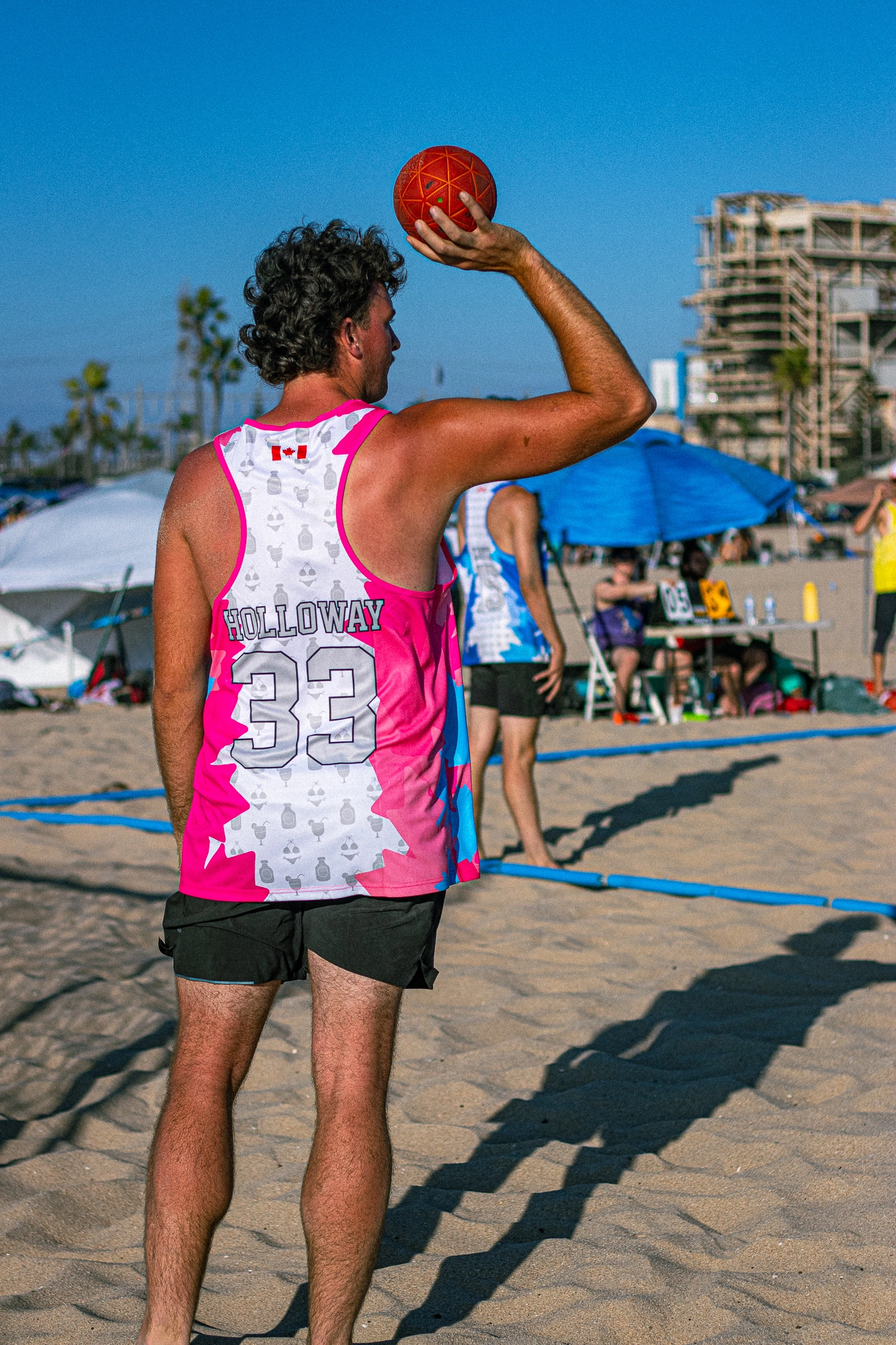 Canadian National Beach Handball Team — player #33 Holloway throwing, custom hot-pink all-over print singlet