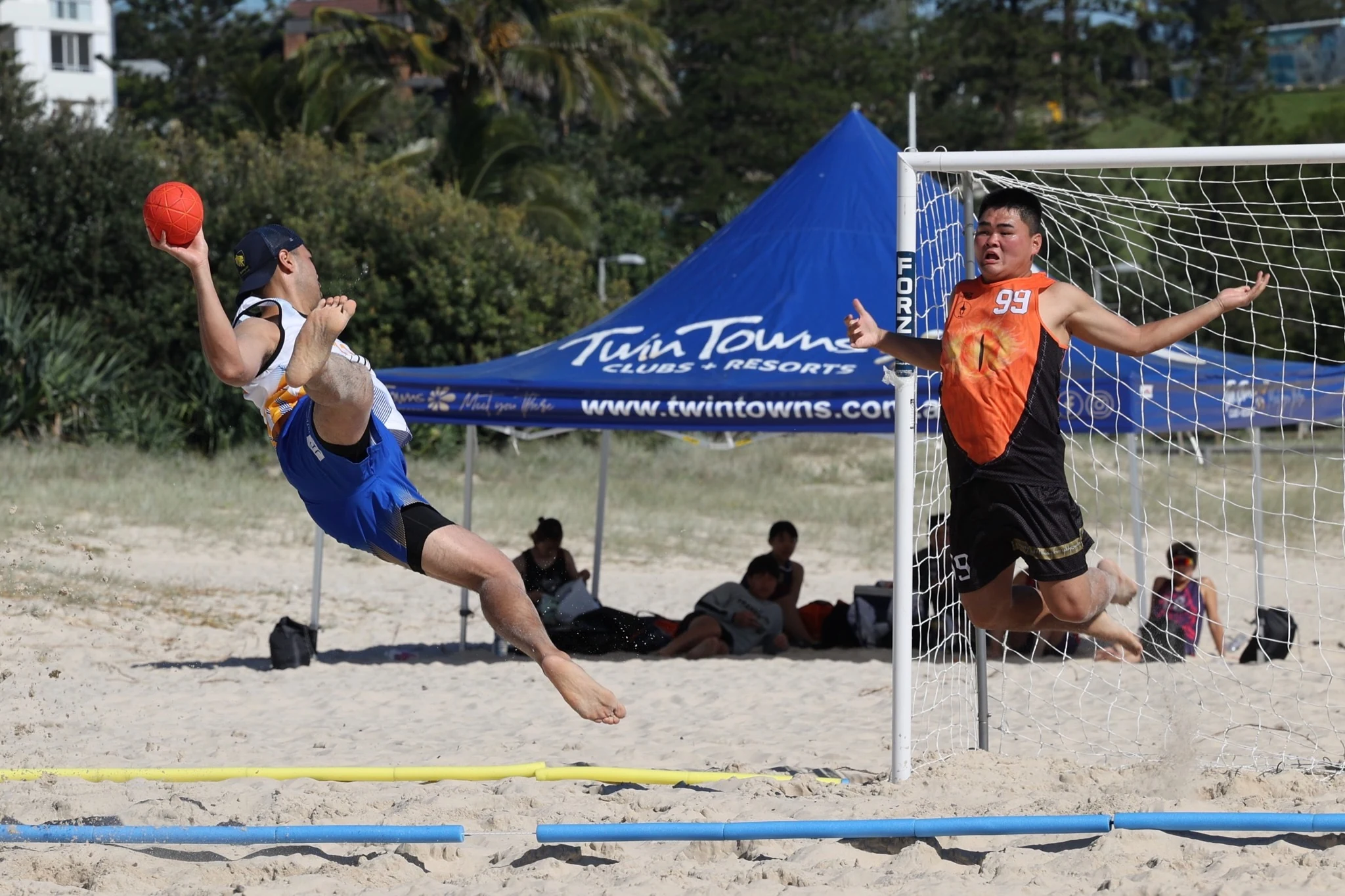 Goalie #99 defending goal, beach handball, Twin Towns tournament